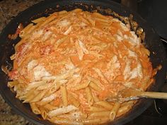 a skillet filled with pasta and sauce