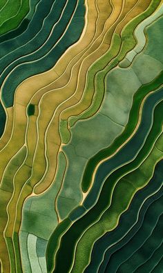 an aerial view of green and yellow hills