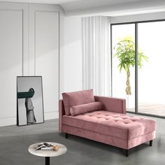 a living room with a pink couch and coffee table