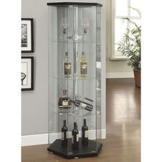 a tall glass case with bottles on it