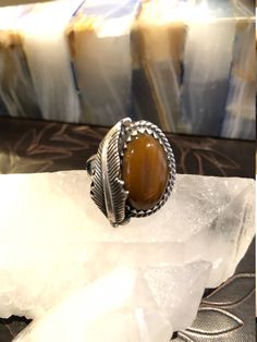 FREE SHIPPING This is such a beautiful Ring! This Ring is made with Sterling Silver and has a beautiful Tigers Eye Stone in it, adorned with a big silver leaf. This can be a Man or Womens Ring. It is size 8 3/4. It is an inch high and almost an inch wide. It has beautiful sterling silver work. The inside is signed by the craftsman, Rogelio Arte and is stamped 925. (I'm not 100% positive that is what the signature says, hard to tell...see all pics). You will LOVE this Ring. It is gorgeous and a g Western Sterling Silver Gemstone Ring, Western Style Sterling Silver Gemstone Ring, Western Style Untreated Sterling Silver Rings, Bohemian Untreated Sterling Silver Ring, Jewelry Men Ring, Tigers Eye Stone, Trifari Brooch, Woman Ring, Womens Ring