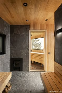 a wooden bench sitting in front of a window next to a wall mounted wood stove