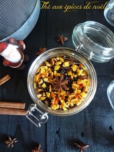 a glass bowl filled with star anise on top of a table next to cinnamon sticks