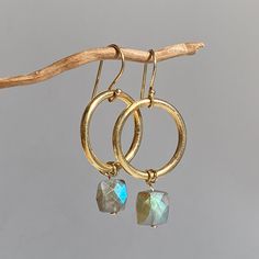 Earrings with beautiful polished labradorite cushions on a ring made of gold-plated sterling silver. The stones look particularly beautiful in combination with gold-plated sterling silver. An absolute favorite piece. The earrings have a length of 4.5 cm and a diameter of approx. 2 cm. Labradorite is said to help promote creative imagination, stimulate the imagination and help generate original ideas. If you are not making progress on something, are stuck and blocked, labradorite stimulates innov Gold Labradorite Round Jewelry, Gold Round Labradorite Jewelry, Gold Faceted Labradorite Jewelry, Gold Labradorite Earrings With Natural Stones, Handmade Gold Labradorite Earrings, Gold Labradorite Drop Earrings, Gold Labradorite Earrings, Creative Imagination, Square Beads