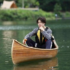 a person sitting in a small boat on the water