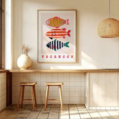 two stools sit in front of a bar with an art print on the wall