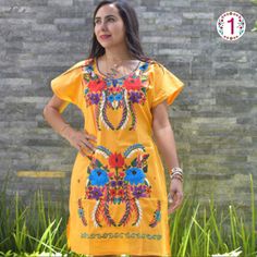 This lovely was handmade in Mexico. The beautiful colorful flowers were embroidered by hand, so each one is unique. You will love wearing this comfortable cotton dress with short sleeves. It is perfect for a hot summer day. This dress comes just above or below the knee, depending on how tall you are. It has a square neckline and cute little puffy sleeves.  Inch measure Medium 19 * 35 Large 23 * 37 XL 26 * 37 XXL 27 * 38 About Our Items: Each one of our items is handmade/hand woven by Indigenous communities of Chiapas and Oaxaca in Mexico. Great care has been taken to ensure the quality and uniqueness of each item we sell.  Our items are made of cotton. Each flower on each item will be a bit different as they were embroidered carefully by hand. Care Instructions: Please take care to handwas Yellow Bohemian Dress For Festivals, Folk Style Multicolor Embroidered Dress With Floral Print, Multicolor Dresses For Fiesta Festivals, Multicolor Fiesta Dresses For Festivals, Multicolor Dresses For Fiesta And Festivals, Folk Multicolor Embroidered Dress For Fiesta, Multicolor Floral Embroidered Tunic Dress, Yellow Tunic Dress With Floral Embroidery, Yellow Bohemian Dress With Floral Embroidery