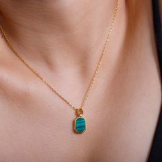 Introducing our Modern Heirloom Malachite Pendant Necklace - a true heirloom piece! This pendant necklace features a stunning malachite stone set in 18K gold plating. With its modern design and timeless charm, this necklace embodies the perfect balance between elegance and uniqueness. Elevate your style with this heirloom piece today! Pendant Height: Including Bail 19.5mmPendant Width: 9mmStone Details: 10mmx7mm Octagonal Malachite Gold Malachite Jewelry For May Birthstone, Gold Emerald Jewelry With Natural Stones, Elegant Malachite Jewelry For May Birthstone, Malachite Gemstone Jewelry For May Birthstone, Gold Malachite Necklace For May Birthstone, Gift Green Onyx Gold Jewelry, Gold Emerald Jewelry, Gold Jewelry With Green Onyx For Gifts, Malachite Emerald Necklace As A Gift