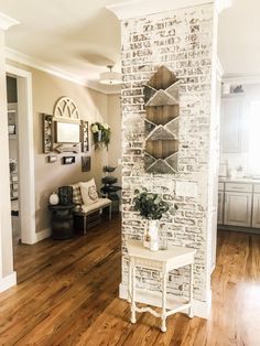 a living room with white brick walls and wooden floors