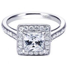 an engagement ring with a princess cut diamond in the center and pave set shoulders