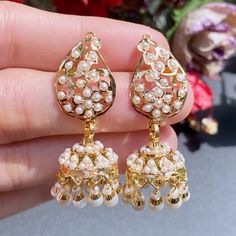 Featuring a handcrafted 22 carat gold necklace with jhumki earrings. This necklace features a traditional design of mango motifs inspired from the Mughal Era of jewellery. The necklace weighs 25.36 gms including 0.75gms in the pearl drops. The jhumki earrings weigh 13.59gms including 1.94 grams in the hanging pearl beads 22k Gold Meenakari Bridal Earrings For Celebration, 22k Gold Bridal Earrings With Meenakari For Celebrations, Elegant White Jewelry For Navratri, Festive White Danglers With Intricate Design, Gold Plated Cutdana Jhumkas As Gift, Yellow Gold Meenakari Jhumkas For Wedding, Elegant Jewelry With Matching Earrings For Navratri, 22k Gold Jhumkas For Celebration, Elegant White Earrings For Navratri