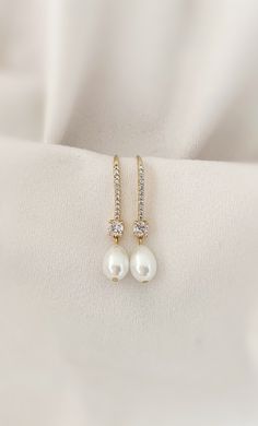 Our pearl drop bridal earrings are simply stunning! A simple classic earring. Little bit of bling, classic pearl, small drop... perfect combo! These long pearl drop earrings catch the light, packing serious sparkle for their size. Combining marquise crystals stones they're finished with glowing pearls. With just the right amount of sparkle, this dainty pair is perfect for brides, mother of the bride and bridesmaids alike. -Drop Pearls are light ivory- These Crystal and pearl wedding earrings will add a flawless finish to every bridal look. ** Delivery is 3 Weeks ** SHOP MORE STYLES https://www.etsy.com/ie/shop/BridalStar?ref=related&listing_id=768478002# *RETURNS- We accept returns . ** Something Blue Earrings Wedding, Elegant Long Drop Pearl Bridal Earrings, Formal Long Drop Pearl Bridal Earrings, Gold Wedding Jewelry Ideas For Bride, Elegant Drop-shape Pearl Earrings For Wedding, Gold-plated Pearl Drop Bridal Earrings For Wedding, Luxury Gold-plated Pearl Drop Bridal Earrings, Bridal Jewelry Pearl Earrings, Brides Mother