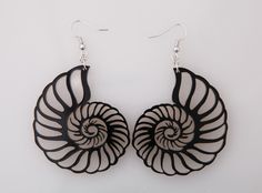 These black acrylic laser cut Nautilus Shell earrings are extra lightweight and easy to wear. The ocean shell gives the earrings a beach style yet any nature, sea or shell lover will love. These also make a great gift. The earring length is 3 inches and the width is 1.75 inches. Nickle free, 21mm brass earring hooks. Handmade Black Earrings For Beach, Acrylic Laser Cut, Camano Island, Nature Sea, Nautilus Shell, Love Stitch, Ceramic Pots, Black Acrylic, Black Acrylics