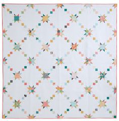 a white quilt with multicolored stars on it