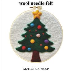 a felt christmas tree ornament hanging from a hoop with the words wool needle felt on it