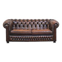 a brown leather couch sitting on top of a white floor