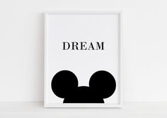 a black and white mickey mouse poster with the word magic on it's face