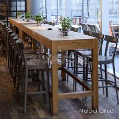 an empty restaurant with wooden tables and chairs