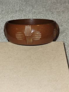 "I will combine shipping on all purchases and refund any overages after shipping fees and insurance. In good vintage condition. Genuine bakelite. Approximately 7.75\" inside. This is a light milk chocolate color that has carved cross looking designs all the way around it. Please look at the pictures for details and condition or message me with any questions" Brown Bakelite Bangle Bracelet, Vintage Carved Brown Bracelets, Vintage Brown Carved Bracelets, Adjustable Brown Vintage Bangle, Vintage Brown Bangle As A Gift, Bakelite Bangles, Chocolate Color, Vintage Butterfly, Matching Bracelets