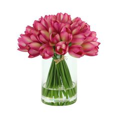 a vase filled with pink flowers sitting on top of a table