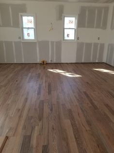 an empty room with hard wood flooring and white paint on the walls is being remodeled