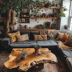 a living room filled with lots of furniture next to a tree trunk coffee table and potted plants