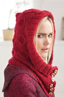 a woman wearing a red hooded jacket with buttons on the hood and she is looking off to the side