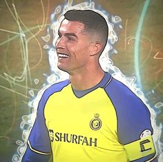 a man in a yellow and blue soccer uniform smiles at the camera while looking to his left