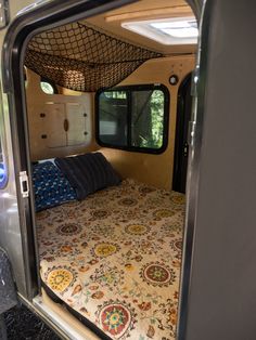 the inside of a camper with a bed in it