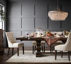 a dining room table with chairs and a chandelier