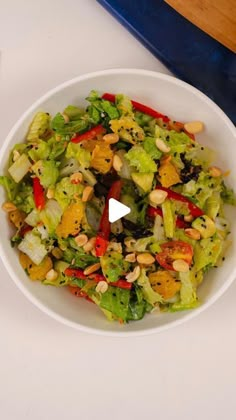 a salad in a white bowl on top of a table