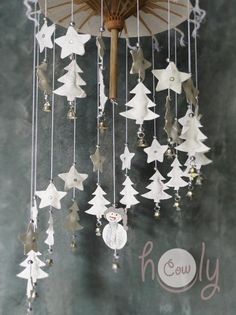 a wind chime hanging from the side of a wall with christmas decorations on it