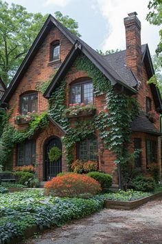 a brick house covered in vines and flowers