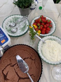 chocolate cake with whipped cream and strawberries on the plate next to other desserts