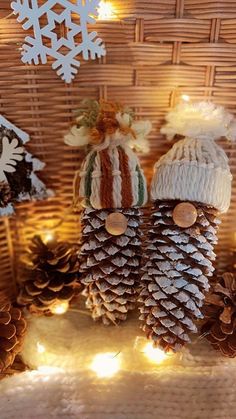 some pine cones are sitting on a table with lights and snowflakes in the background