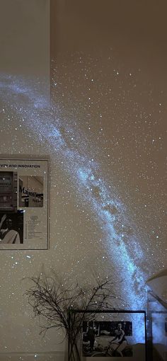 the stars are shining in the night sky above a vase with a plant on it