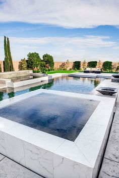 an outdoor swimming pool in the middle of a park