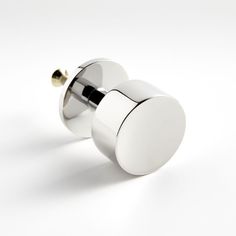 two round knobs on white surface with gold accents