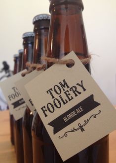 several brown bottles with labels on them sitting on a table