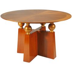 a round wooden table with two pedestals on each side