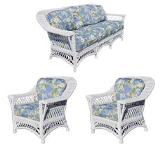 three white wicker chairs with blue floral cushions