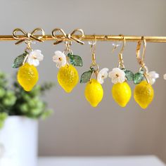 Brighten up your look with our handmade Czech glass lemon earrings! 🍋Elevate your style and add a pop of freshness to any outfit. Shop now at Rain Designs! Our lovely lemon fruit earrings are crafted with Czech glass lemons, acrylic flowers and 14K gold plated earring hooks which are good for delicate ears. We have silver version available, please contact the seller for detail. The lemons are very juicy, you may want to make it a set! We offer matching necklace which is made with 14k gold-plate Lemon Earrings, Lemon Wedding, Earrings For Bride, Lemon Flowers, Rain Design, Lemon Lemonade, Lemon Fruit, Etsy Ideas, Food Earrings