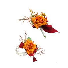 two boutonnieres with orange roses and pearls on them are sitting next to each other