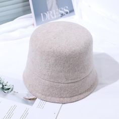 The Emes Shop hat is detailed with a sleek minimalist design. Features a solid color. wool material. and cloche hat design.MATERIAL:100% Brushed Wool BlendCIRCUMFERENCE MEASUREMENTS: 56-58cm 22-23in Beige Cloche Hat With Curved Brim For Fall, Beige Felt Hat With Short Brim For Winter, Beige Short Brim Felt Hat For Winter, Beige Brimmed Felt Hat For Winter, Beige Winter Fedora Hat, Classic Fall Cloche Hat, Beige Fedora Winter Hat, Classic Solid Cloche Hat For Fall, Classic Solid Color Cloche Hat For Fall