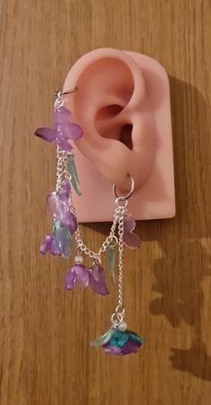 Introducing our gorgeous handmade butterfly and rose earrings. These are available in purple, red and pink, with the choice of helix and earring or if you wish just dangle earrings. These butterfly designs are intricately sculpted, capturing the ethereal essence of these enchanting creatures with wings poised in mid-flight, accentuated by subtle, shimmering details that catch the light with every movement. Complementing the butterflies, the rose motifs are artfully shaped, showcasing the intrica Handmade Dangle Cartilage Earrings As Gift, Handmade Dangle Cartilage Earrings For Gift, Gift Dangle Cartilage Earrings, Unique Handmade Dangle Cartilage Earrings, Handmade Unique Dangle Cartilage Earrings, Unique Pierced Dangle Flower Earrings, Unique Dangle Flower Earrings, Whimsical Purple Dangle Flower Earrings, Party Jewelry With Butterfly Dangle Charm