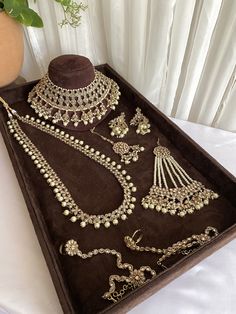 an assortment of jewelry is displayed on a tray