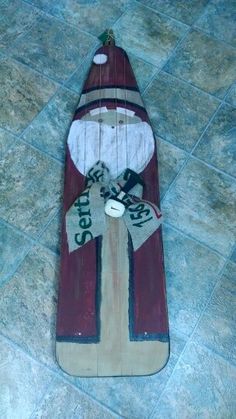 a skateboard with a red and white striped design on it sitting on the ground