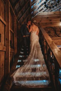 a bride and groom walking down the stairs at their rustic barn wedding in pennsylvania, united states