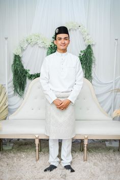 a man standing in front of a white couch