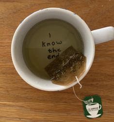 a cup of tea with some kind of substance in it that says i know the end